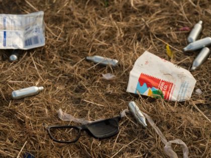 Discarded nitrous oxide canisters are scattered on the ground in front of the Pyramid Stage at the end of the Glastonbury Festival of Music and Performing Arts on Worthy Farm near the village of Pilton in Somerset, South West England, on June 26, 2017. / AFP PHOTO / Oli SCARFF …