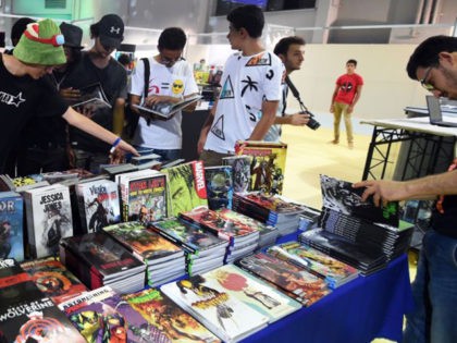 Young Tunisians look through copies of comic books and graphic novels during the opening of the second edition of Comic Con Tunisia on July 7, 2017, in the town of Le Kram, north of Tunis. / AFP PHOTO / FETHI BELAID (Photo credit should read FETHI BELAID/AFP via Getty Images)