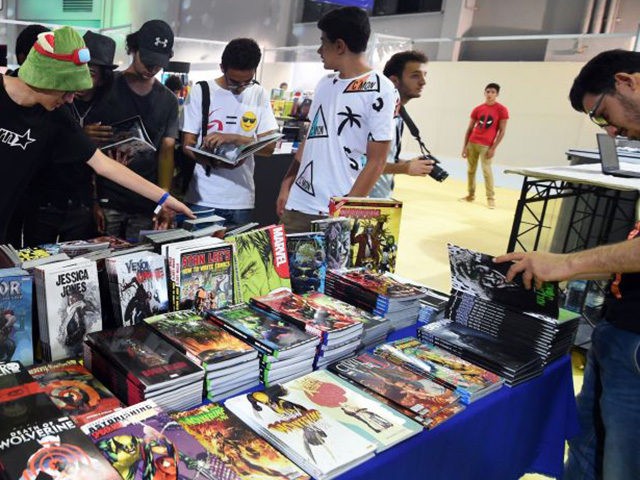 Young Tunisians look through copies of comic books and graphic novels during the opening o