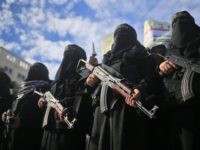 TOPSHOT - Armed female members of the militant Palestinian group Islamic Jihad carry Kalashnikov assault rifles as they take part in a rally to protest against US President Donald Trump's decision to recognise Jerusalem as the capital of Israel, in Gaza City on December 11, 2017. / AFP PHOTO / …