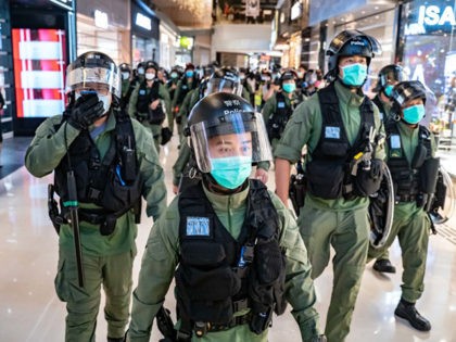 HONG KONG, CHINA - JULY 21: Riot police secure an area inside a shopping mall during a rally on July 21, 2020 in Hong Kong, China. Protesters gathered to mark one year since the Yuen Long mob attack at the Yuen Long MTR station. (Photo by Anthony Kwan/Getty Images)