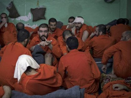 Men, suspected of being affiliated with the Islamic State (IS) group, gather in a prison c