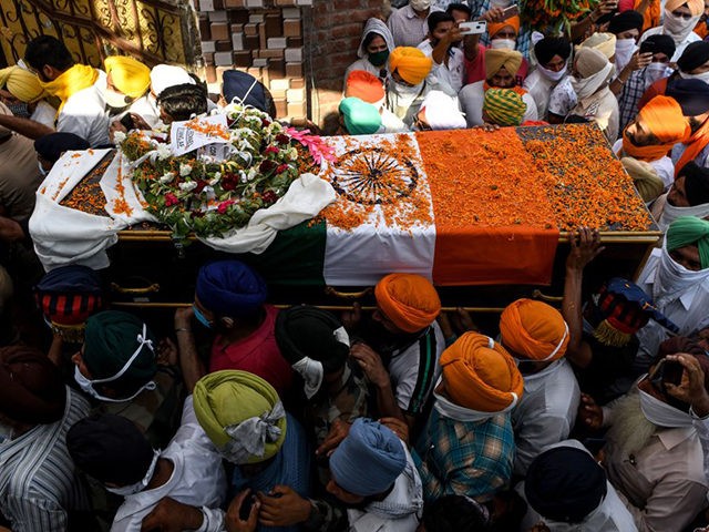 Family members and villagers carry the coffin of soldier Satnam Singh who was was killed i