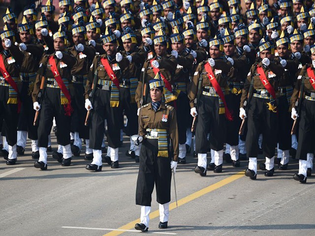 Indian Army captain Tania Shergill (C) leads an all-male contingent as they march along Ra