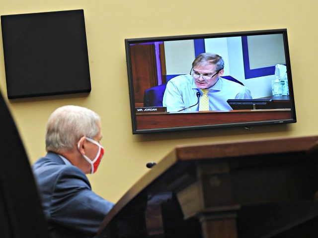 WASHINGTON, DC - JULY 31: Dr. Anthony Fauci, director of the National Institute for Allergy and Infectious Diseases, listens as Rep. Jim Jordan, R-Ohio, is seen speaking on a monitor at a House Subcommittee on the Coronavirus Crisis hearing on July 31, 2020 in Washington, DC. Trump administration officials are …