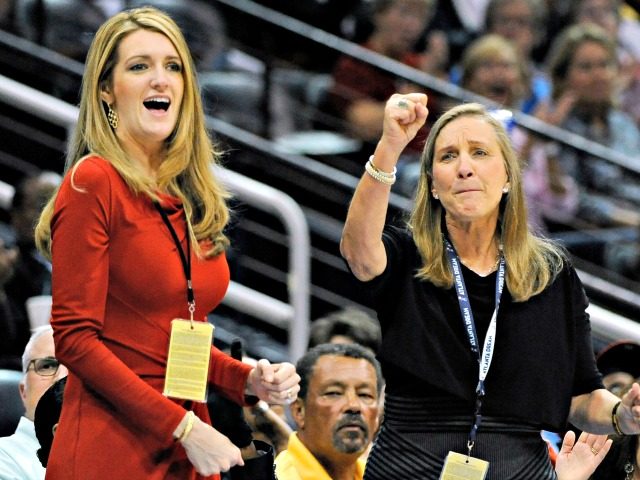 FILE-In this Sept. 6, 2011 file photo, Mary Brock, right, and Kelly Loeffler cheer from their courtside seats as the Atlanta Dream basketball team plays in the second half of their WNBA basketball game, in Atlanta. A GOP political consultant told The Associated Press that Georgia Gov. Brian Kemp decided …