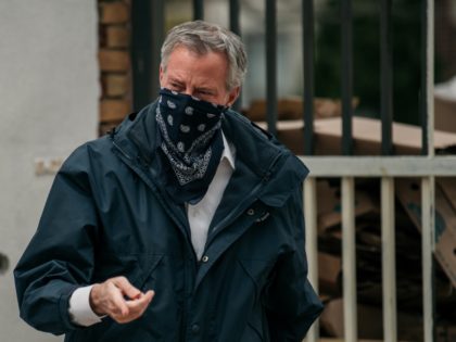 New York City Mayor Bill de Blasio wears a bandana over his face while speaking at a food shelf organized by The Campaign Against Hunger in Bed Stuy, Brooklyn on April 14, 2020 in New York City. Before touring the facility de Blasio praised the work of food shelves and …
