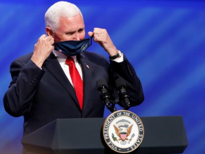 Vice President Mike Pence removes his mask to make comments at First Baptist Church Dallas