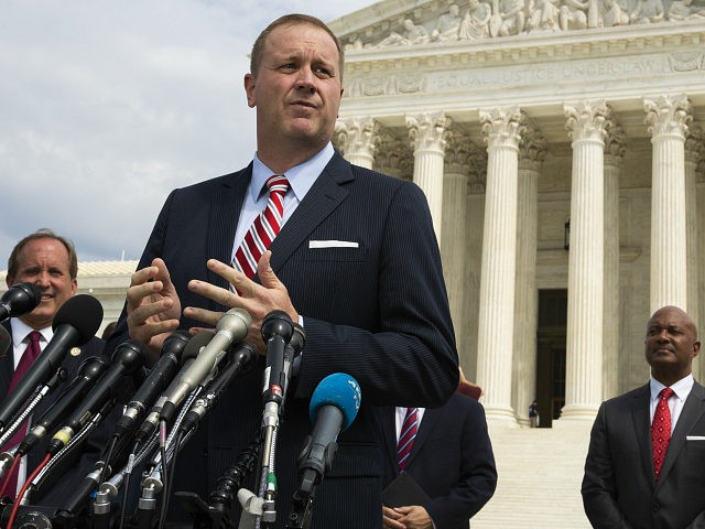 FILE - In this Sept. 9, 2019, file photo, Missouri Attorney General Eric Schmitt speaks in front of the U.S. Supreme Court in Washington. Schmitt on Tuesday, April 21, 2020, filed a lawsuit against the Chinese government, the Community Party of China and others, alleging that the hiding of information …