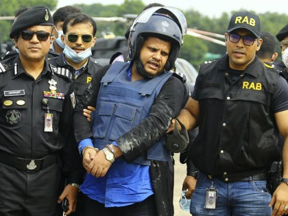Mohammed Shahed, center, the owner of two hospitals that issued thousands of fake coronavirus test reports is brought by helicopter after being arrested by Bangladesh's Rapid Action Battalion personnel in Dhaka, Bangladesh, Wednesday July 15, 2020. Shahed, a member of the governing party who regularly appeared on TV talk shows, …