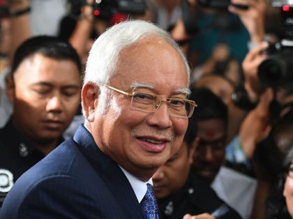 Malaysia's former prime minister Najib Razak (C) leaves a court in Kuala Lumpur on April 3