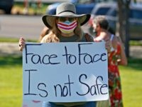 Kris Reddout, a 5th grade teacher, attends a Utah Safe Schools Mask-In urging the governor's leadership in school reopening during a rally Thursday, July 23, 2020, in Salt Lake City. Parents and teachers rallied at the Utah State Capitol Thursday morning to urge schools to enforce mask wearing and to …