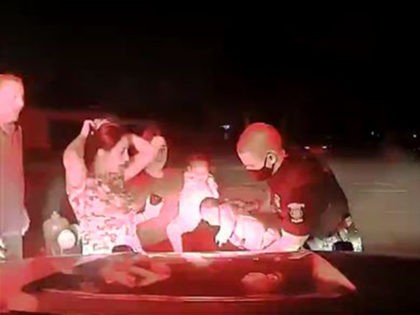 Officer Cameron Maciejewski saves an infant's life on the dashboard of his vehicle