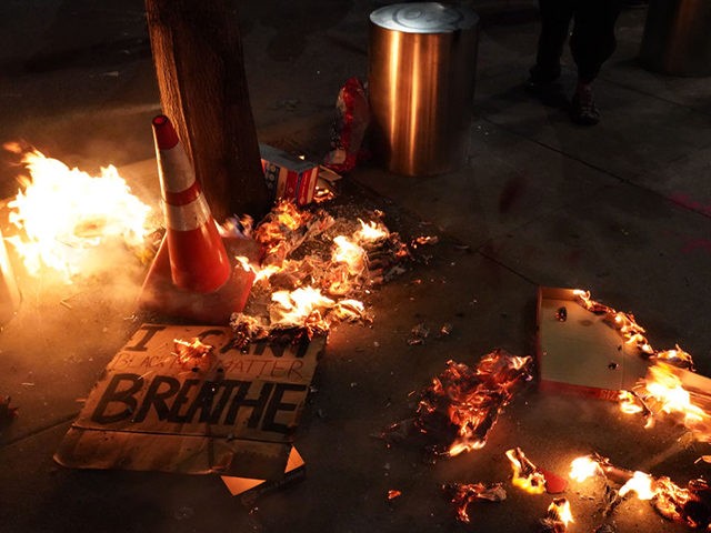 PORTLAND, OR - JULY 20: A fire burns around a sign reading I cant breathe during a protest in front of the Mark O. Hatfield U.S. Courthouse on July 201, 2020 in Portland, Oregon. Monday night marked 54 days of protests in Portland following the death of George Floyd in …