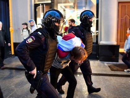 Police officers detain a participant of a protest against the results of July 1 national vote which approved reforms to the Russian constitution, including a reset for President Vladimir Putin's constitutional term limit that allows him to run two more times and remain in power until 2036, in downtown Moscow …