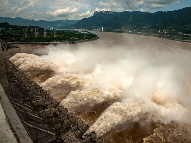 This photo taken on July 19, 2020 shows water being released from the Three Gorges Dam, a gigantic hydropower project on the Yangtze river, to relieve flood pressure in Yichang, central China's Hubei province. - Rising waters across central and eastern China have left over 140 people dead or missing, …