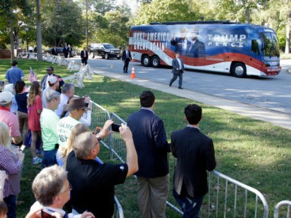 Supporters take photos as a bus carrying Republican vice presidential candidate, Indiana Gov. Mike Pence arrives at a campaign event at Catawba College in Salisbury, N.C., Monday, Oct. 24, 2016. (AP Photo/Chuck Burton)