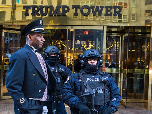 Heavily armed New York City Police (NYPD) officers stand guard at the entrance of Trump To
