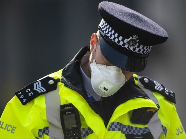 LONDON, ENGLAND - APRIL 09: A police officer in a mask stands guard outside St Thomas' Hospital on April 09, 2020 in London, England. Prime Minister Boris Johnson is still being cared for in the intensive care unit at St Thomas' Hospital after his coronavirus symptoms worsened on Monday night. …