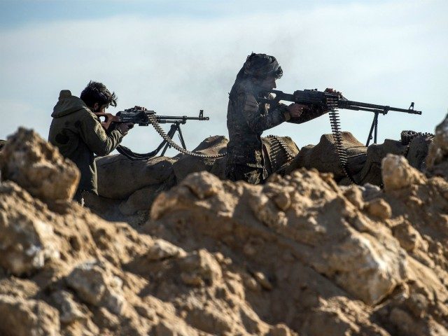 Fighters with the US-backed Syrian Democratic Forces (SDF) keep a position during an operation to expel Islamic State group (IS) jihadists from the Baghouz area in the eastern Syrian province of Deir Ezzor on February 13, 2019. - Syrian fighters backed by artillery fire from a US-led coalition battled a …