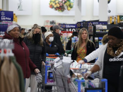 People wearing masks and gloves wait to checkout at Walmart on April 03, 2020 in Uniondale, New York. The World Health Organization declared coronavirus (COVID-19) a global pandemic on March 11th. (Photo by Al Bello/Getty Images)