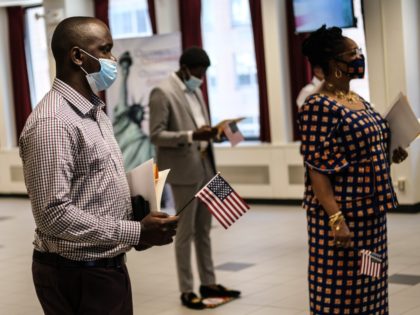 NEW YORK, NY - JULY 02: People are sworn in as new American citizens during a ceremony at the U.S. Citizenship and Immigration Services New York Field Office on July 2, 2020 in New York City. The ceremonies were brief and observed precautions, like wearing a mask and adhering to …