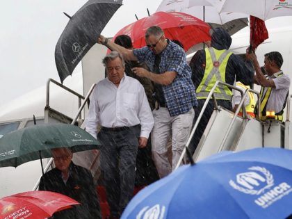 UN Secretary-General Antonio Guterres (C, white shirt) arrives in Cox's Bazar on July 2, 2018, on a visit to meet with Rohingya refugees who are living in camps near the Bangladesh-Myanmar border. - UN Secretary-General Antonio Guterres is visiting Bangladesh to assess needs for dealing with hundreds of thousands of …