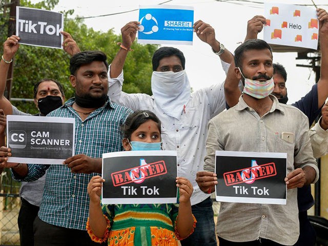 Members of the City Youth Organisation hold posters with the logos of Chinese apps in support of the Indian government for banning the wildly popular video-sharing 'Tik Tok' app, in Hyderabad on June 30, 2020. - TikTok on June 30 denied sharing information on Indian users with the Chinese government, …