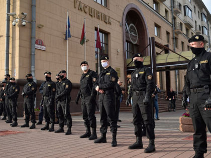 Riot police officers block an area as people gather outside the election commission headquarters to file their complaints over the electoral body's refusal to register Viktor Babaryko as a candidate for the presidential election in August, Minsk, July 15, 2020. (Photo by Sergei GAPON / AFP) (Photo by SERGEI GAPON/AFP …