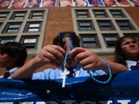 NEW YORK, NY - SEPTEMBER 25: People gather and wait for Pope Francis to arrive at Our Lady Queen of Angels School on September 25, 2015 in the East Harlem neighborhood of New York City. The Pope visited the inner city Catholic school in east Harlem and met with school …