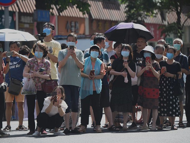 People stand on a road leading to the US Consulate in Chengdu, southwestern China's Sichua