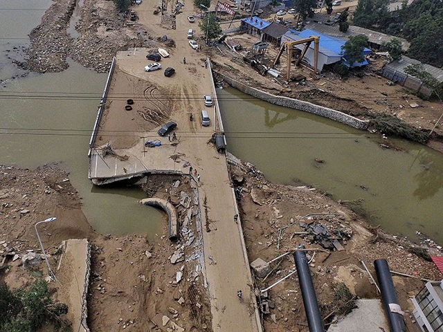 This photo taken on July 23, 2016 shows a bridge damaged by recent floodwaters in Daxian village in Xingtai, north China's Hebei province. As of July 25, morning more than half a million people in the hardest-hit provinces of Henan and Hebei had been displaced, with 125,000 people in urgent …
