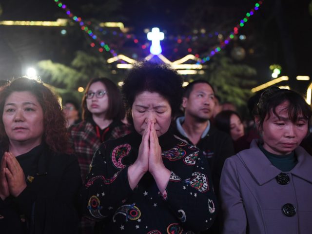 Chinese Catholics attend a mass on Holy Saturday, part of Easter celebrations at Beijing's government sanctioned South Cathedral on March 31, 2018. Chinese Catholics are taking part in Easter celebrations as China and the Vatican continue talks on a historic agreement on the appointment of bishops in China. / AFP …