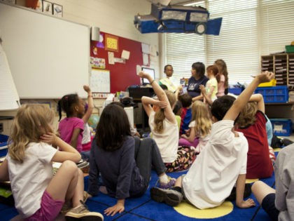 Classroom with students with hands raised