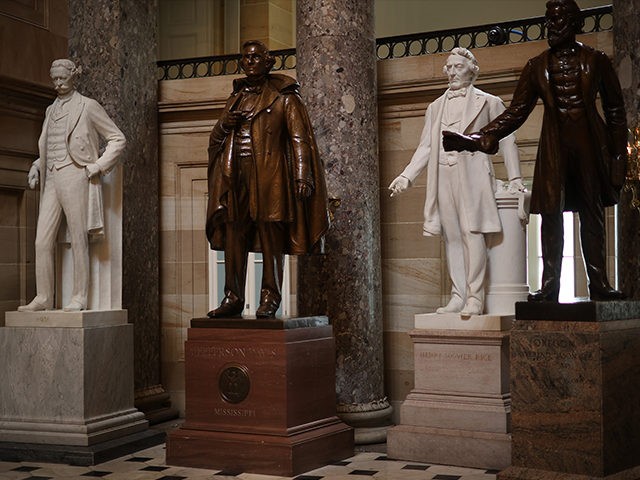 WASHINGTON, DC - JUNE 18: Statues of Jefferson Finis Davis (2nd L), president of the Confederate States from 1861-1865, and Uriah M. Rose (L), an Arkansas county judge and supporter of the Confederacy, are on display in Statuary Hall inside the U.S. Capitol June 18, 2020 in Washington, DC. Speaker …