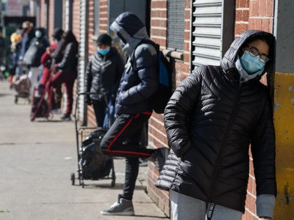 NEW YORK, NY - MAY 09: Recipients of the nonprofit organization The River Fund wait in line to receive free groceries on May 9, 2020 in the Queens borough of New York City. The River Fund, which has quadrupled their once-weekly food distribution since the beginning of the coronavirus-shutdown seven …
