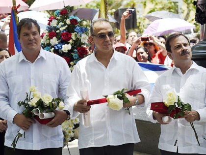(L-R) Ramon Labanino, Antonio Guerrero and Fernando Gonzalez, three of the "Cuban Five" intelligence agents arrested in Miami in 1998 and convicted of espionage, talk at the end of a ceremony in Caracas on May 4, 2015. The Cuban spies whose release by the United States helped pave the way …