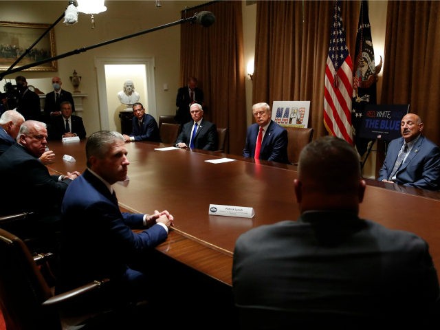President Donald Trump listens during a meeting with leaders of some of the national law e