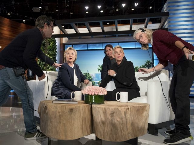 Staff speak with Democratic presidential candidate Hillary Clinton and Ellen Degeneres during a commercial break at a taping of The Ellen Show in Burbank, Thursday, Oct. 13, 2016. (AP Photo/Andrew Harnik)