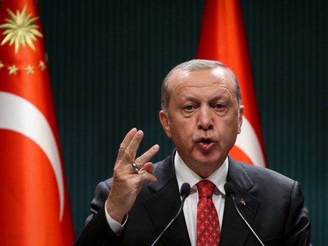 Turkish President Recep Tayyip Erdogan gestures as he delivers a speech following a cabine