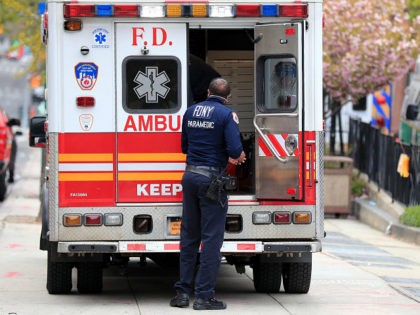 NEW YORK, NY - APRIL 23: A FDNY paramedic unloads a patient from an ambulance near the Eme
