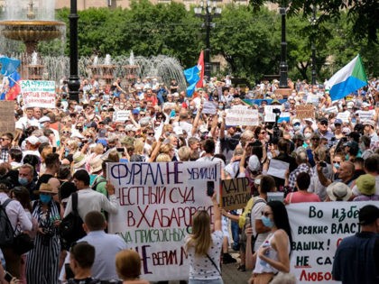 People hold banners and signs during an unauthorised rally in support of Sergei Furgal, the governor of the Khabarovsk region who was arrested, in the Russian far eastern city of Khabarovsk on July 25, 2020. - Huge anti-government demonstrations erupted in Russia's Far East on July 25 over the arrest …