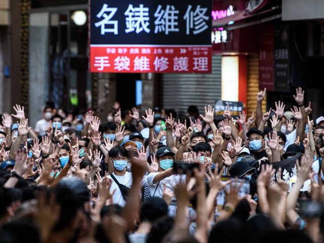 TOPSHOT - Protesters chant slogans and gesture during a rally against a new national security law in Hong Kong on July 1, 2020, on the 23rd anniversary of the city's handover from Britain to China. - Hong Kong police arrested more than 300 people on July 1 -- including nine …
