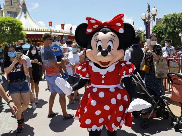 The iconic cartoon character Minnie Mouse waves to visitors at the Hong Kong Disneyland on