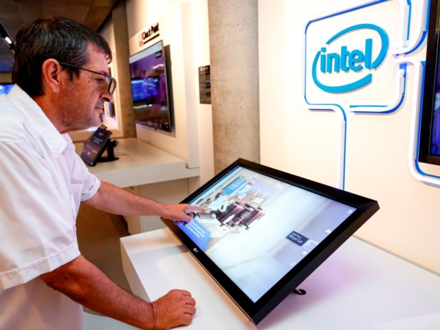A visitor interacts with a display by Intel, at a technology exhibit at the Peres Center for Peace and Innovation in the Israeli coastal city of Tel Aviv on September 3, 2019. - The Peres Centre for Peace and Innovation serves in part as a shrine to Israel's long list …