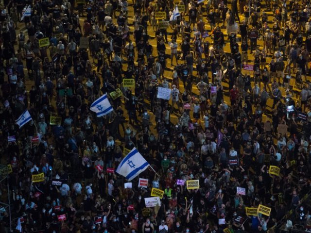 TEL AVIV, ISRAEL - JULY 11: Thousands of Israelis Protest against the Government's economy response to the cororna virus crisis on July 11, 2020 in Tel Aviv, Israel. Following a rise in the cases of COVID-19, Israeli Prime Minister Benjamin Netanyahu has ordered many businesses to shut, causing people to …