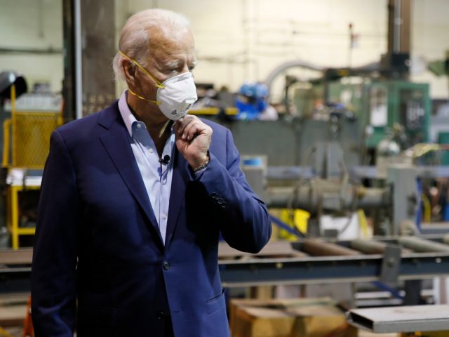 Democratic presidential candidate, former Vice President Joe Biden adjusts his mask during a tour of McGregor Industries, a metal fabricating facility, Thursday, July 9, 2020, in Dunmore, Pa. (AP Photo/Matt Slocum)