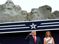 US President Donald Trump and First Lady Melania Trump pay their respects as they listen to the National Anthem during the Independence Day events at Mount Rushmore National Memorial in Keystone, South Dakota, July 3, 2020. (Photo by SAUL LOEB / AFP) (Photo by SAUL LOEB/AFP via Getty Images)