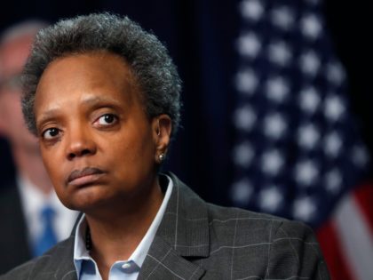 Chicago mayor Lori Lightfoot listens to a question after Illinois Gov. J.B. Pritzker announced a shelter in place order to combat the spread of the Covid-19 virus, during a news conference Friday, March 20, 2020, in Chicago. (AP Photo/Charles Rex Arbogast)