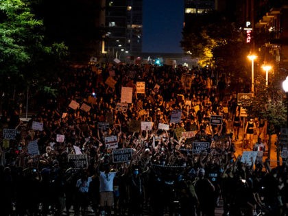 MINNEAPOLIS, MN - JULY 04: Demonstrators march to the Stone Arch Bridge during the Black 4